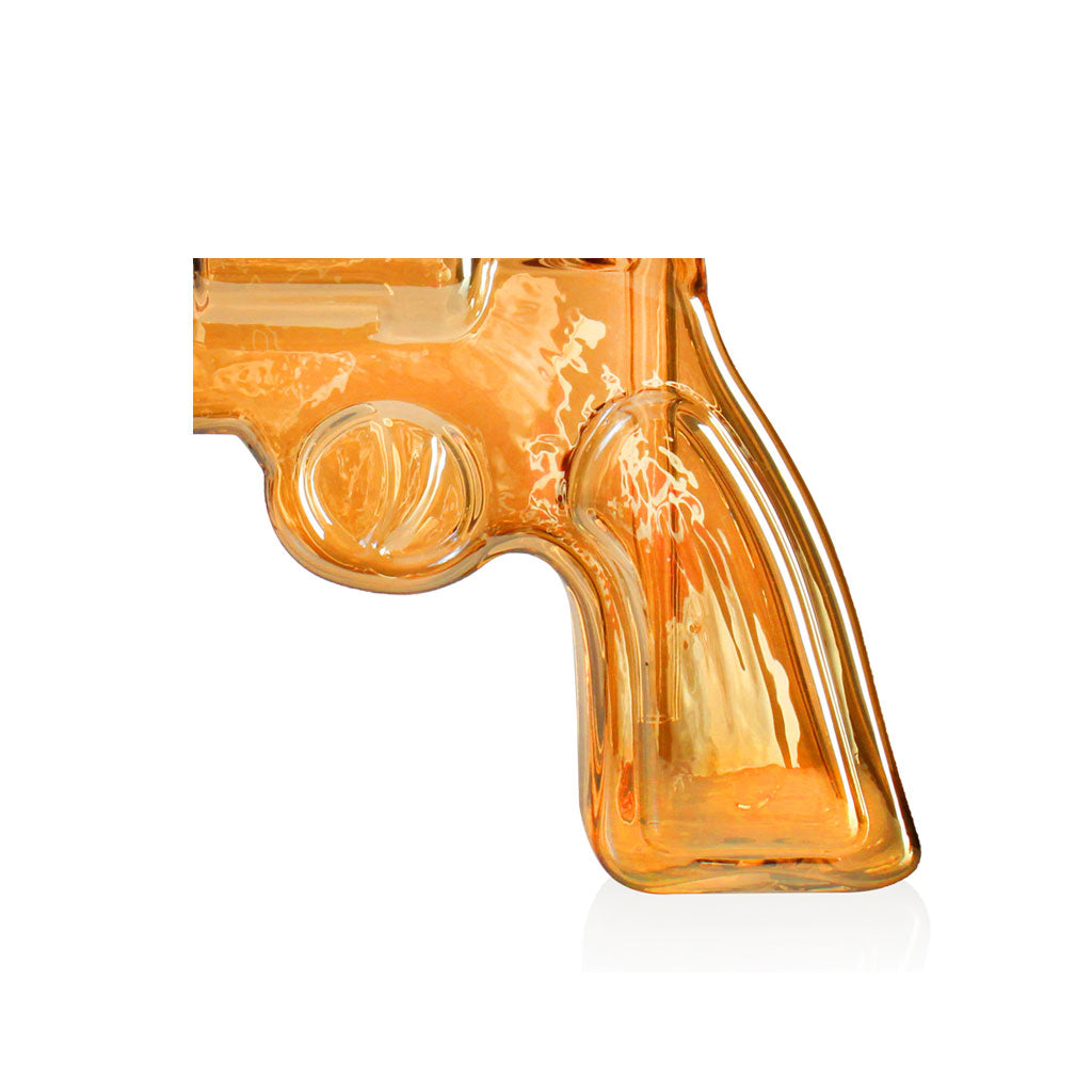 Close-up of the amber revolver bong grip and trigger area, showing the glossy glass finish.