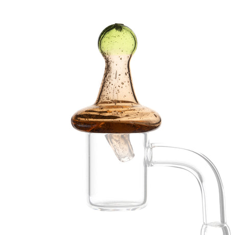Glow in the dark amber directional carb cap from Fat Ass Glass shown in low light highlighting the green glow effect and glass body